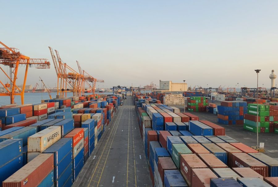 Large container ships at port with stacked shipping containers and cargo handling operations