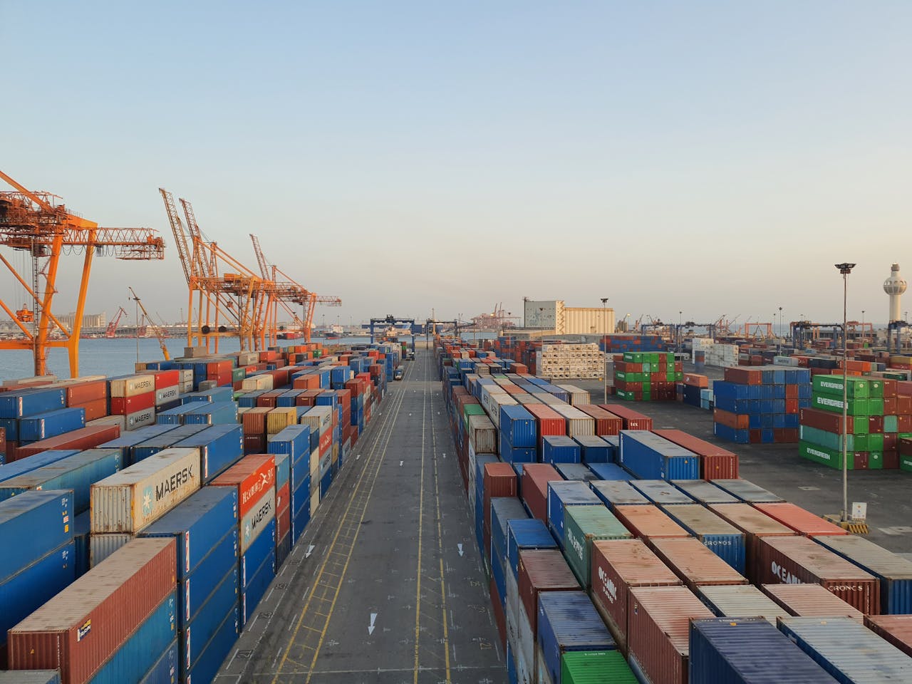 Large container ships at port with stacked shipping containers and cargo handling operations