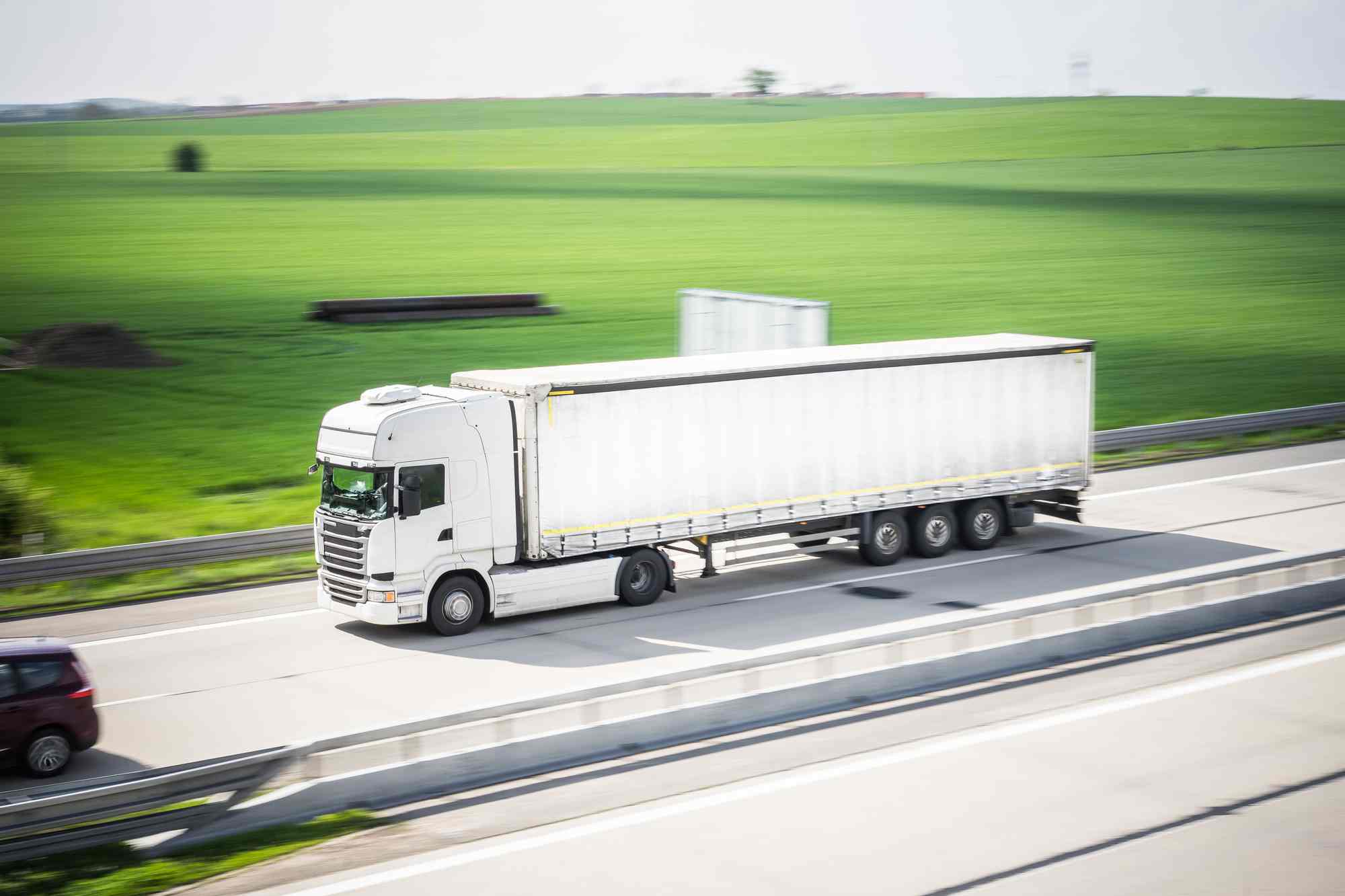 White Truck Driving on a Motorway